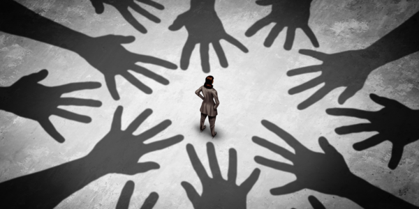 Image of a person surrounded by shadows depicting how social anxiety symptoms